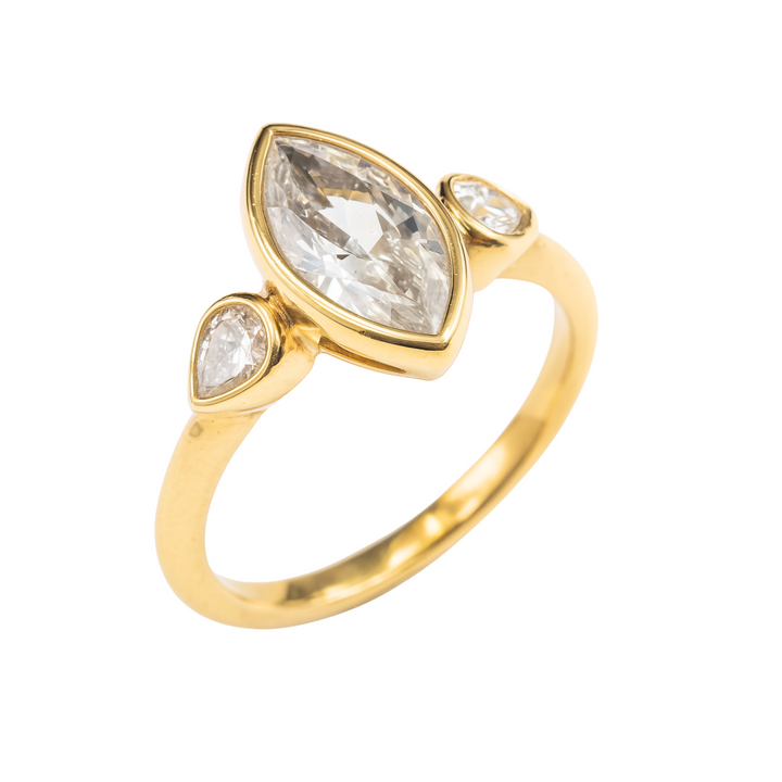 Angled View of Marquise Lab Grown Diamond Engagement Ring with Pear Accents 3 Stone Bezel Setting in Yellow Gold | Rare Earth Jewelry