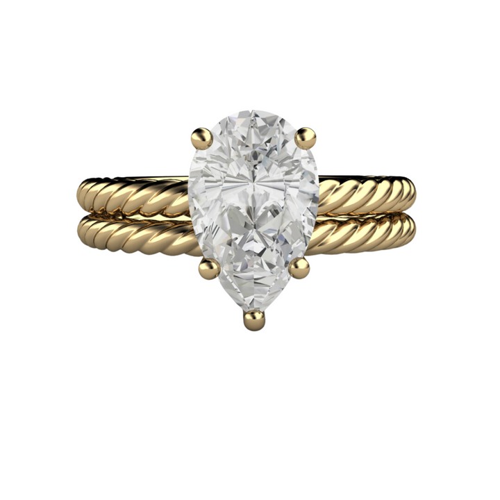 Pear cut engagement ring in 18K Yellow Gold solitaire setting with a twisted band bridal set.