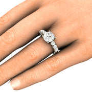 A 2ct round moissanite solitaire engagement ring on the finger with an 8mm round moissanite.