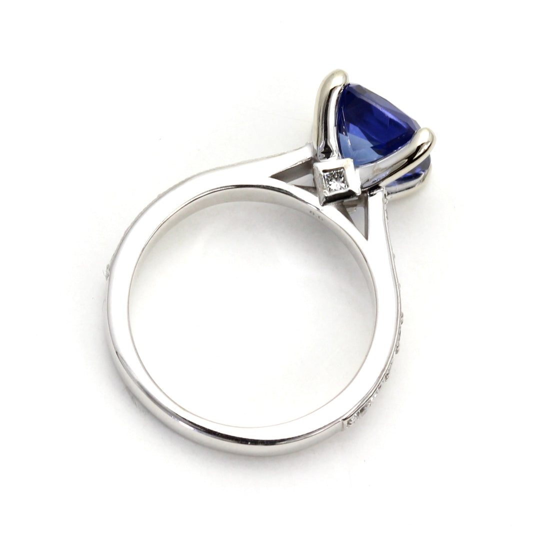 A 3ct Cushion Cut Sapphire Solitaire Engagement Ring viewing the Cathedral Setting with Hidden Diamond | Rare Earth Jewelry