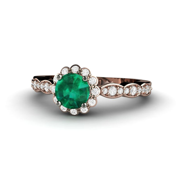Rose Gold Emerald ring with diamond halo and vintage inspired design.