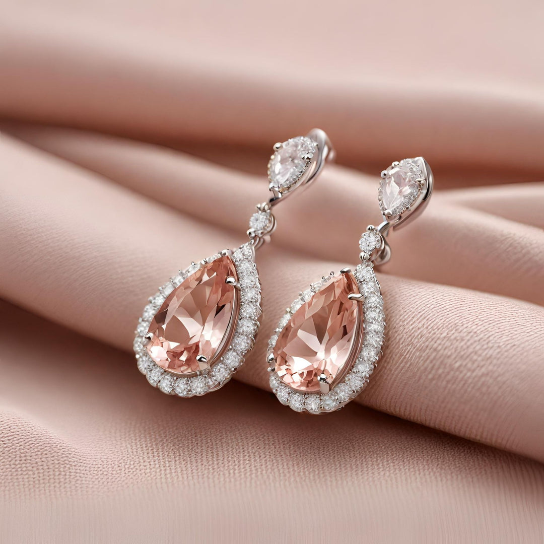 Morganite pear cut earrings in 14K Gold drop design. Perfect peach pink drop dangle earrings for a bride from Rare Earth Jewelry.
