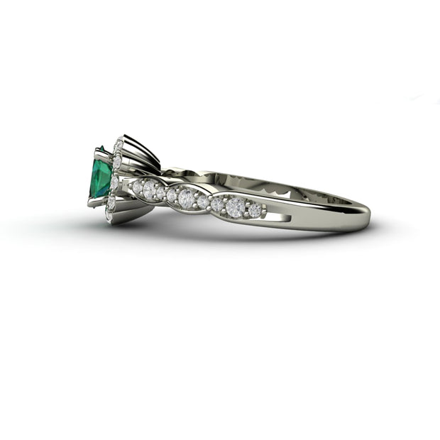 Side view of the vintage inspired emerald and diamond ring.