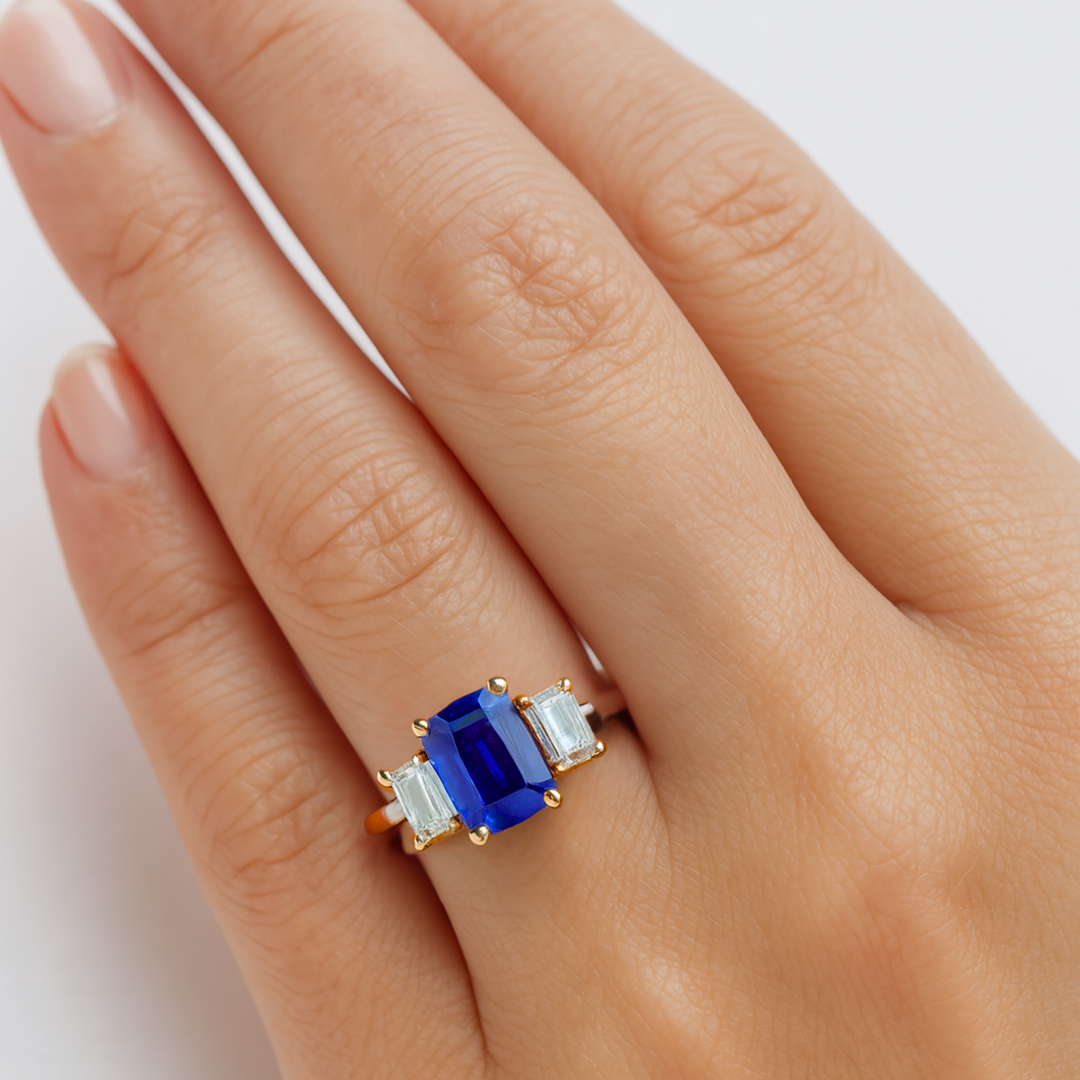 Three Stone Emerald Cut Blue Sapphire Engagement Ring on the Hand, Lab Grown Blue Sapphire Ring with Diamond Accents | Rare Earth Jewelry
