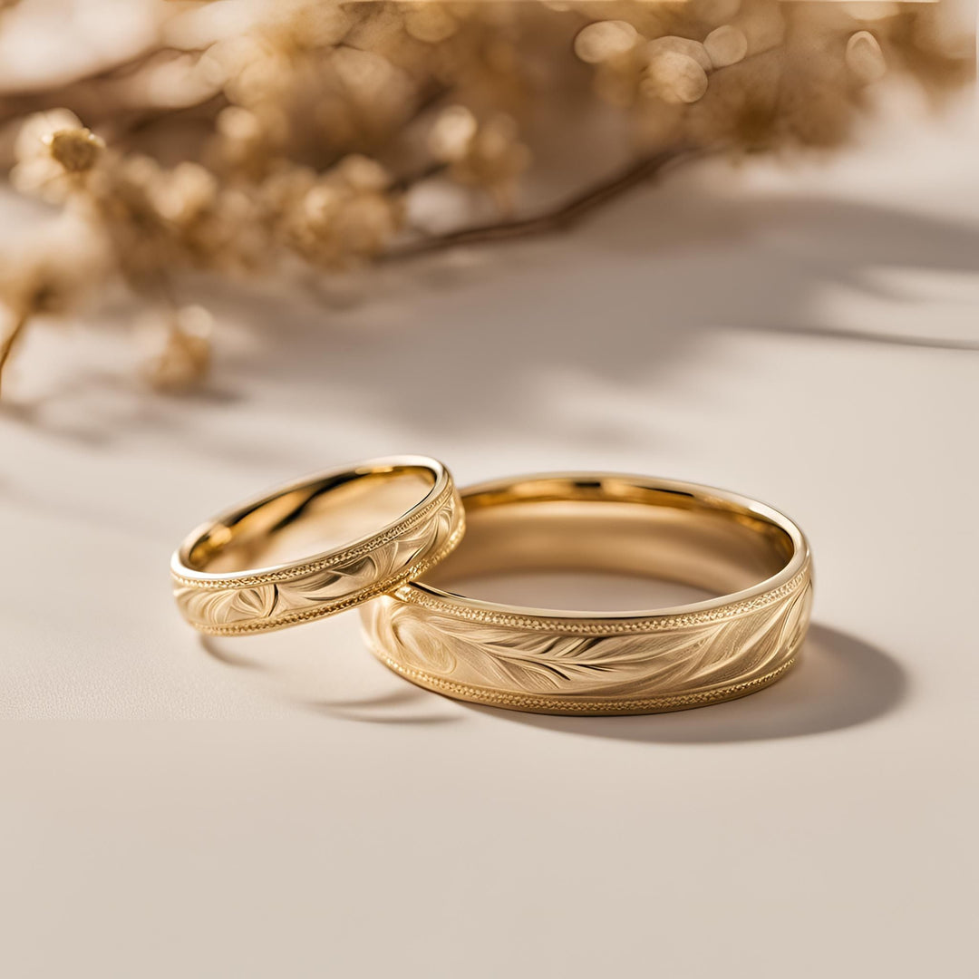14K Gold wedding rings with an engraved leaf design and milgrain, his and hers vintage style wedding bands from Rare Earth Jewelry.
