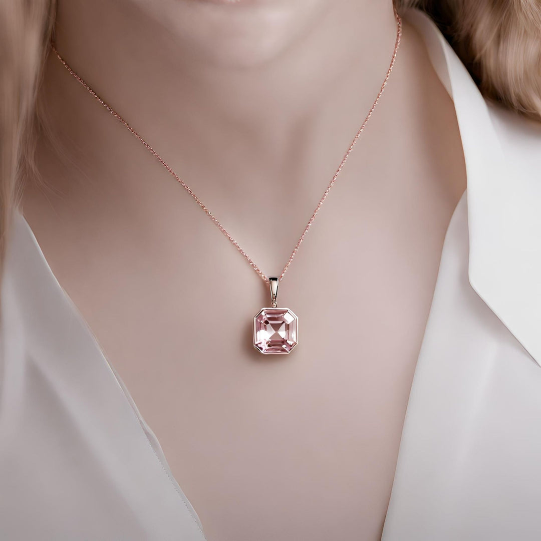 A large asscher cut Pink Morganite pendant necklace with a modern elegant bezel setting in rose gold on a dainty 14K Gold chain from Rare Earth Jewelry