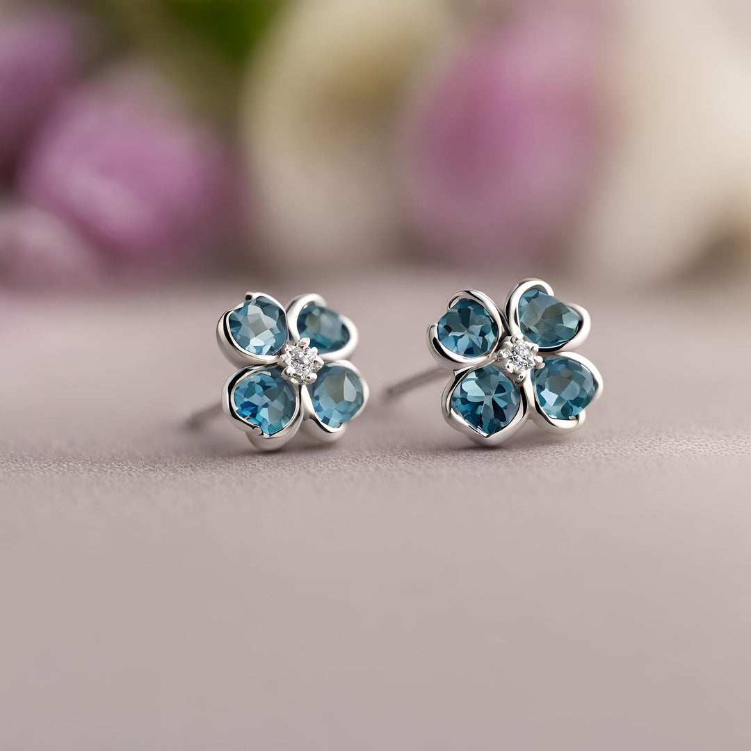 14K Gold London Blue Topaz earrings. Flower earrings with heart shaped gemstones and a diamond center from Rare Earth Jewelry.