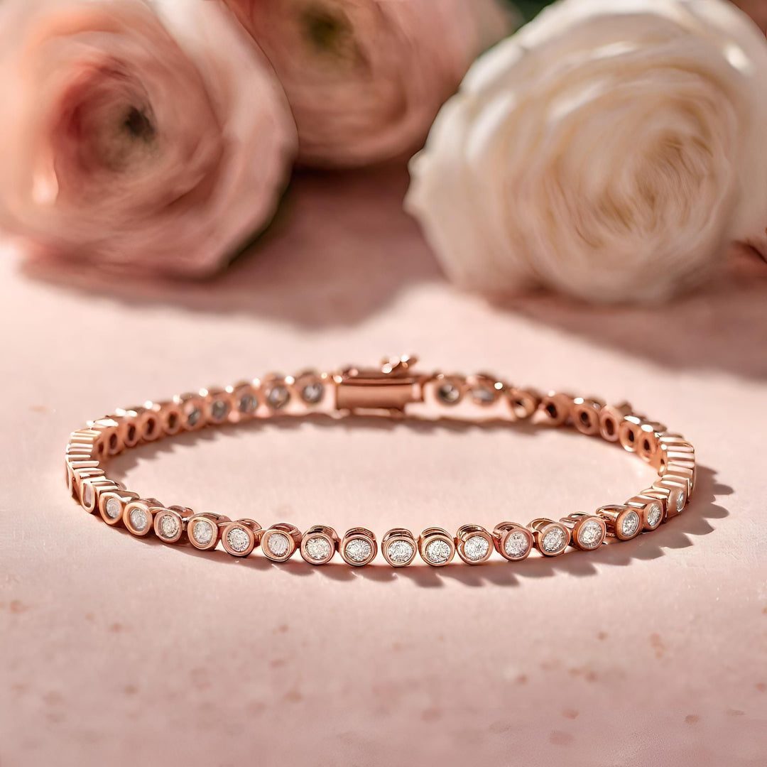 Round bezel set diamond tennis bracelet in 14K rose gold from Rare Earth Jewelry.