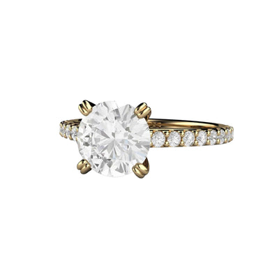 A 2 carat round Forever One Moissanite Solitaire Engagement Ring with a Pave set Band and Double Prongs, shown in Yellow Gold from Rare Earth Jewelry.