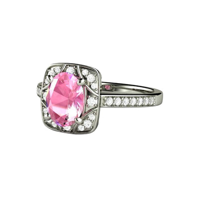 An oval Pink Sapphire Engagement ring with Diamonds in an antique style setting with an Art Deco Geometric design available in gold or platinum from Rare Earth Jewelry.