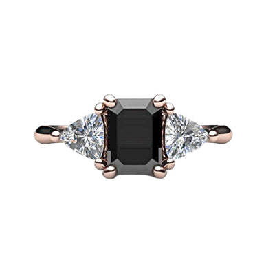 A natural Black Diamond Engagement Ring in a vintage 3 stone style with an emerald cut black diamond and diamond trillions in gold or platinum, shown in rose gold from Rare Earth Jewelry.