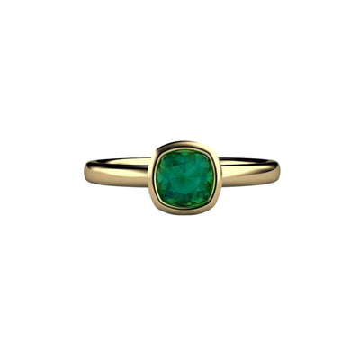 A cushion cut natural blue green tourmaline ring in a simple, modern bezel set solitaire design, shown here in yellow gold from Rare Earth Jewelry.