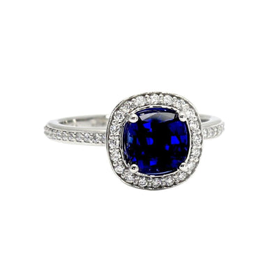 A blue sapphire cushion cut engagement ring with diamond halo in gold or platinum from Rare Earth Jewelry.
