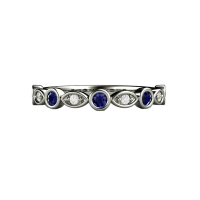 A Blue Sapphire and Diamond wedding ring, anniversary band, mother's ring or stacking ring.  The band has round bezel set blue sapphires and diamonds in gold or platinum from Rare Earth Jewelry.