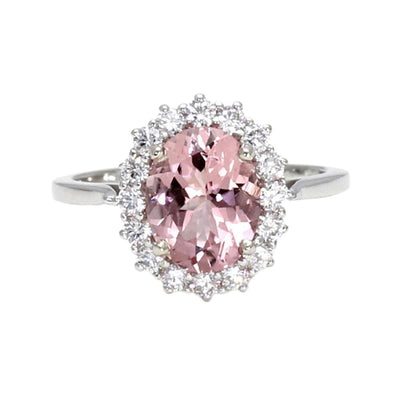 An oval natural pink Morganite engagement ring with a vintage inspired cluster design with a halo of diamonds in gold or platinum from Rare Earth Jewelry.