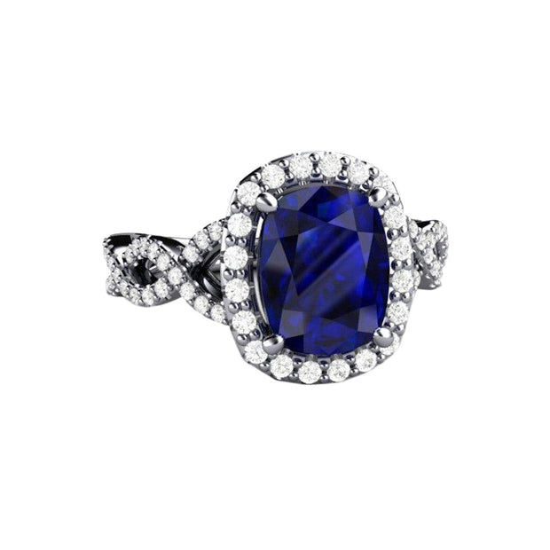 A large rectangular cushion cut Blue Sapphire engagement ring with diamond accents, an infinity design split shank with diamond accents and diamond halo in gold or platinum.