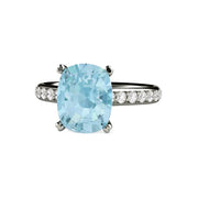 A large rectangular cushion cut natural Aquamarine engagement ring in a solitaire setting with diamond accents in gold or platinum.  March birthstone ring from Rare Earth Jewelry.