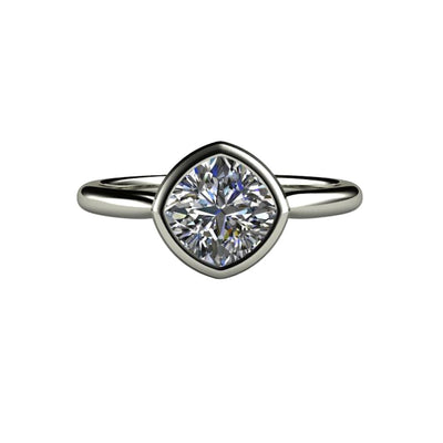 A cushion cut Moissanite engagement ring in a simple bezel-set solitaire design with a 1.20ct cushion cut Charles & Colvard Forever One Moissanite from Rare Earth Jewelry.