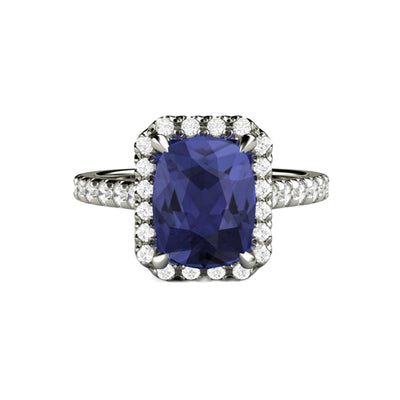 A rectangular cushion cut natural Tanzanite engagement ring in a french pave diamond halo setting with claw prongs in gold or platinum from Rare Earth Jewelry..