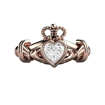 An Irish Claddagh ring, Rose gold Diamond Claddagh Ring with a bezel-set heart-cut natural diamond. Traditional design of heart, hands, and crown symbolizes love, loyalty, and friendship. Perfect for an engagement ring or promise ring from Rare Earth Jewelry.