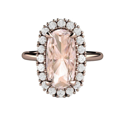 A natural peach Morganite engagement ring with a 2 carat elongated cushion cut center surrounded by a diamond halo in a unique vintage-inspired cluster design in rose gold with a feminine feel and dainty claw prongs from Rare Earth Jewelry.