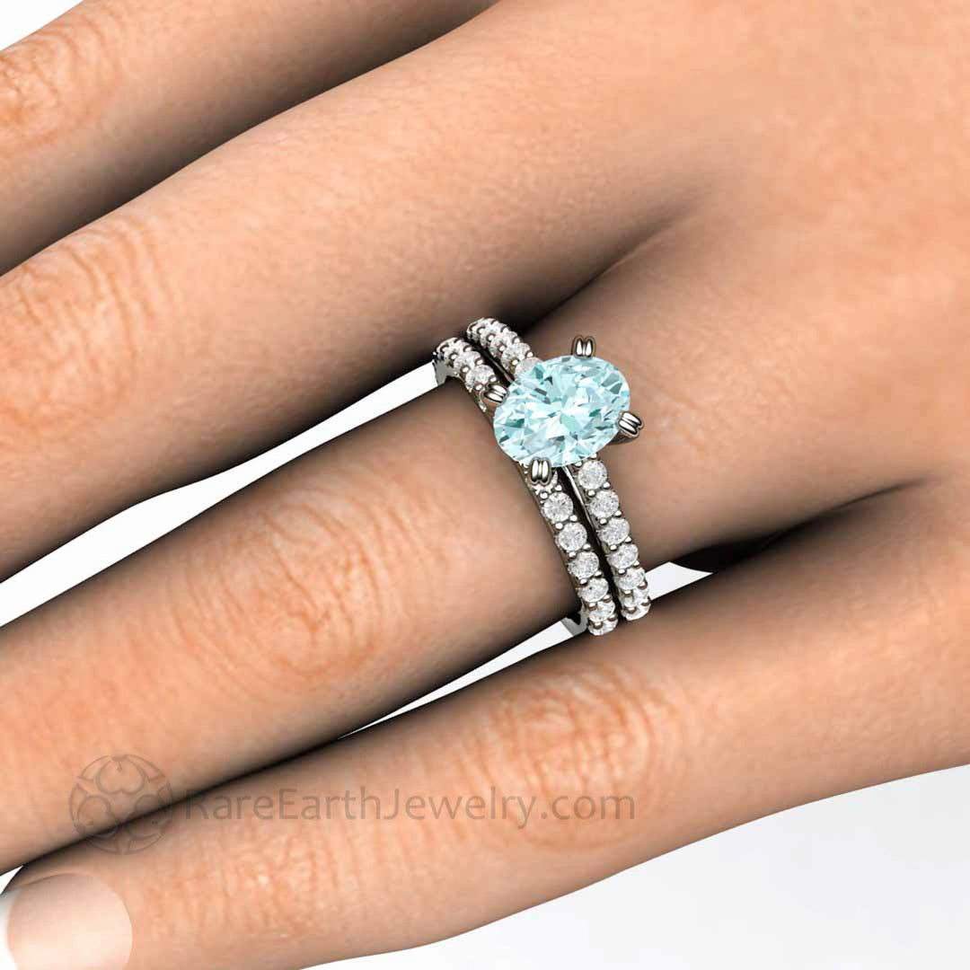 Oval Aquamarine Engagement Ring, Solitaire Setting with Pave Diamond Accents and Double Prongs Shown with the Matching Wedding Band on the Hand