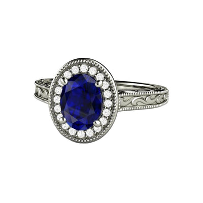 A vintage inspired oval Blue Sapphire engagement ring with an Art Deco style and diamond halo, with scrollwork and milgrain beaded details in 14K, 18K or Platinum from Rare Earth Jewelry.