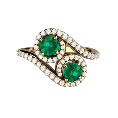 An Antique Style Emerald Ring in a two stone Toi et Moi design.  A unique emerald and diamond engagement ring, shown in yellow gold.