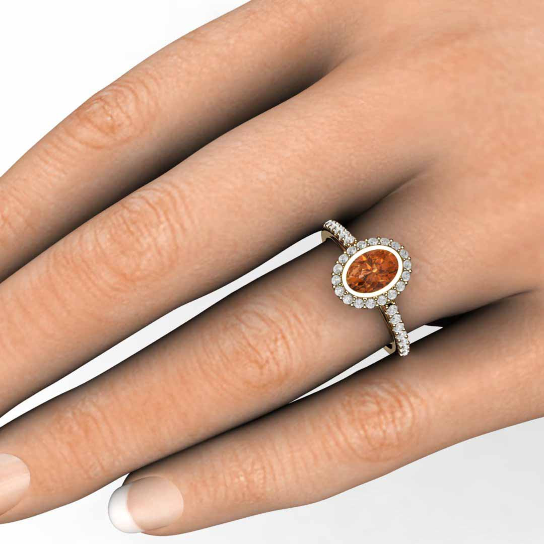 Oval Orange Sapphire Engagement Ring on the Finger, Bezel Seting with Pave Set Diamonds | Rare Earth Jewelry