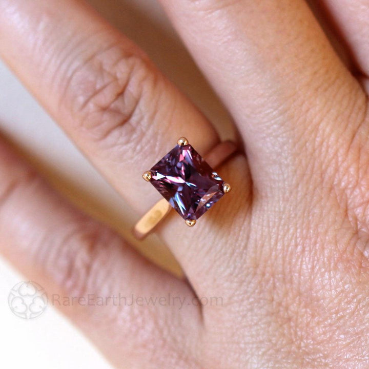 Color Change Sapphire Ring on the Hand, Unique Blue Gemstone turns  Purple and Pink in the Light.  Emerald Cut Sapphire Engagement Ring | Rare Earth Jewelry
