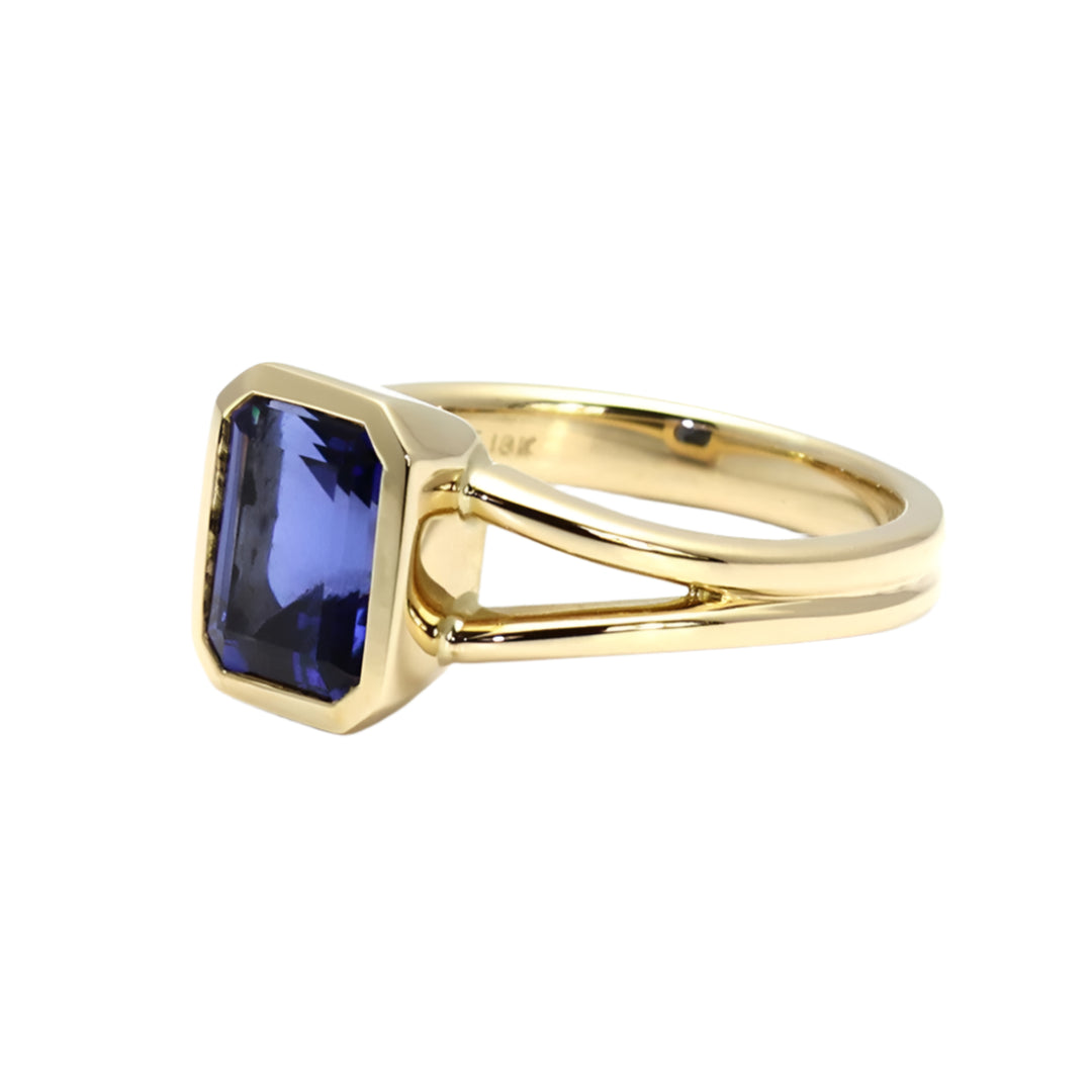 Emerald cut Blue Sapphire Bezel ring with split band in Yellow Gold | Rare Earth Jewelry
