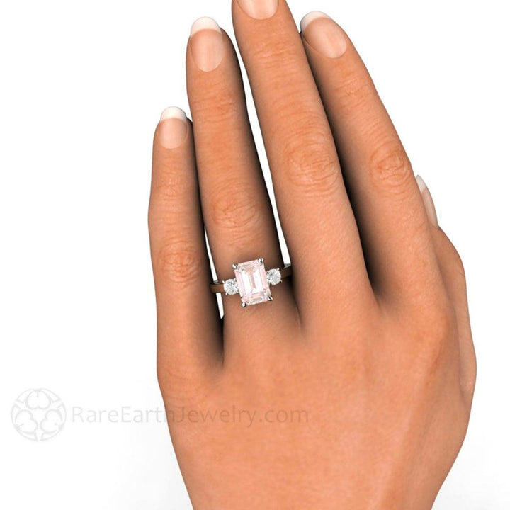 Emerald Cut Pink Morganite Engagement Ring shown on the hand, Three Stone Ring with Diamonds in 14K or 18K Gold | Rare Earth Jewelry