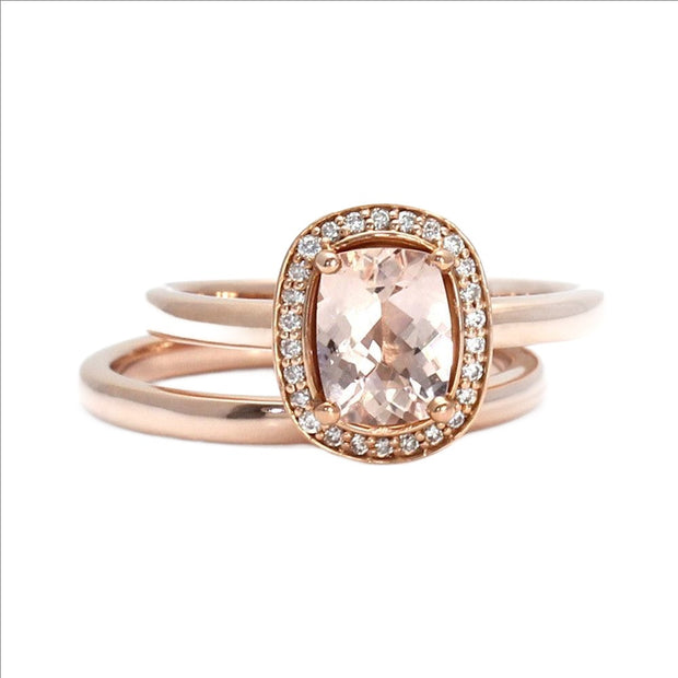 A natural Morganite engagement ring in a classic diamond halo design with a peach rectangular cushion cut center and diamond accents. The wedding set includes the wedding band from Rare Earth Jewelry