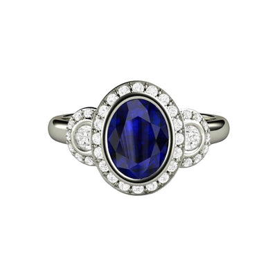 Antique Style Oval Blue Sapphire Engagement Ring with Bezel Setting and Diamond Halo in Gold or Platinum from Rare Earth Jewelry.
