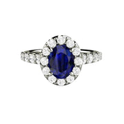 Oval Blue Sapphire Engagement Ring with a Pave Set Diamond Halo and Accented Band in Gold or Platinum from Rare Earth Jewelry