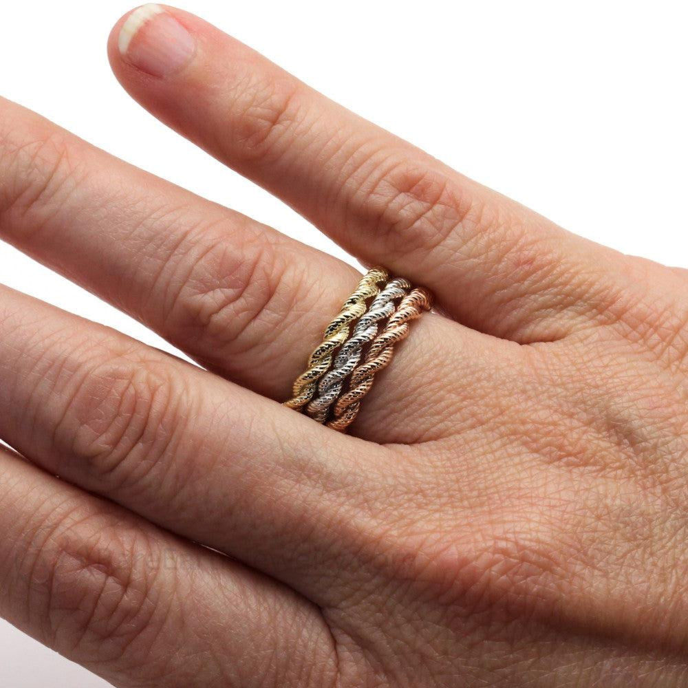 A stack of 3 rope design stacking rings on the finger. 3mm Woven wedding bands in 14K White Gold, Yellow Gold and Rose Gold on the Hand | Rare Earth Jewelry
