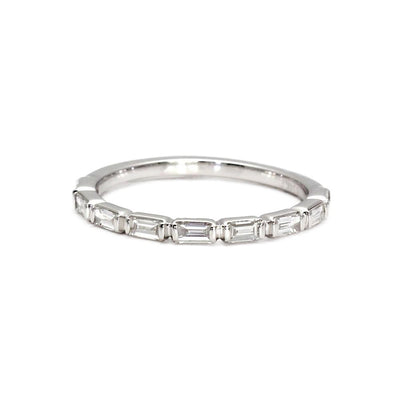A diamond baguette band with natural diamonds set east to west in a modern bar set design, stackable band or wedding ring from Rare Earth Jewelry