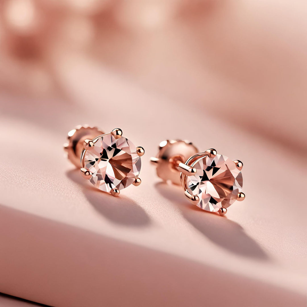 A pair of round Morganite stud earrings in 14K Rose Gold 6 prong basket settings from Rare Earth Jewelry.