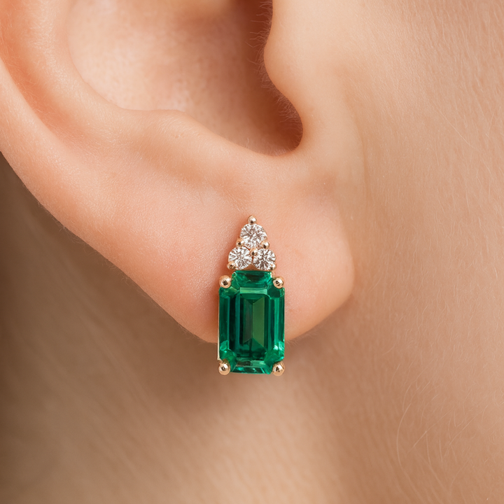 14K Gold Emerald Earrings with Diamonds shown on the Ear | Emerald Cut Studs May Birthstone | Rare Earth Jewelry