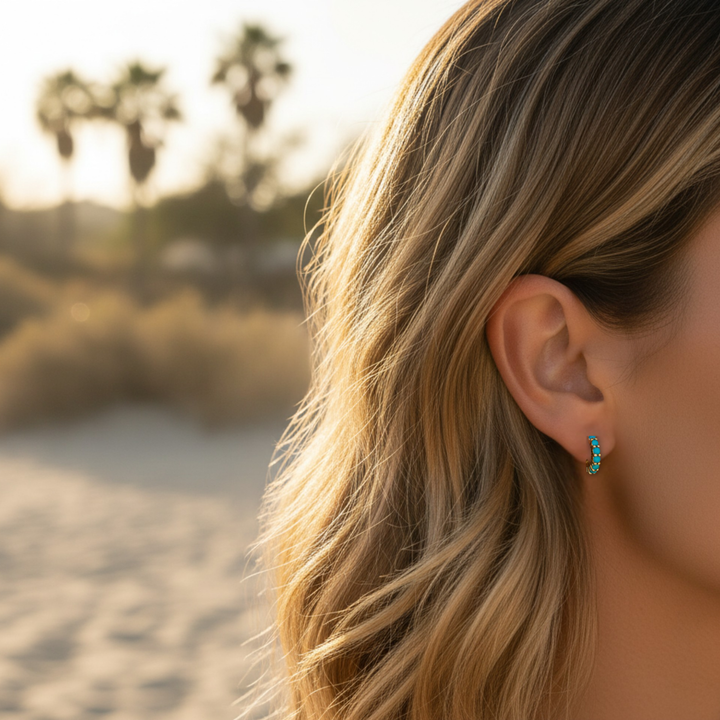 Small turquoise hoop earrings shown on model, 12mm gold huggie hoops with natural turquoise cabochons | Rare Earth Jewelry