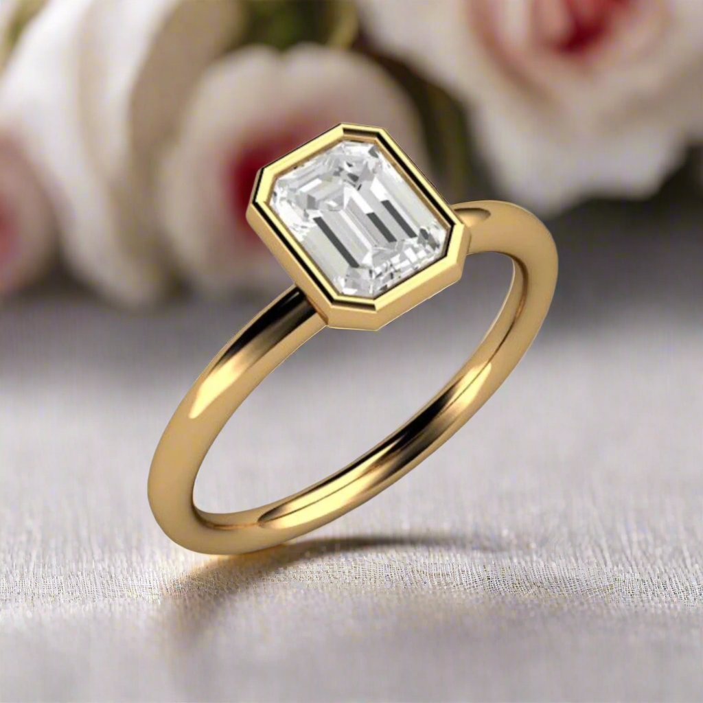 1ct emerald cut natural diamond engagement ring, modern bezel set solitaire, minimalist style, 18K yellow gold.