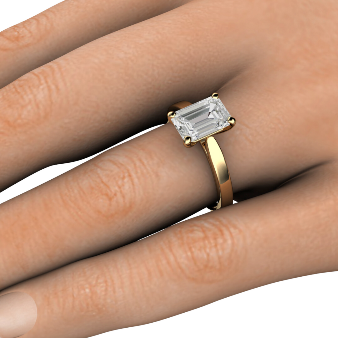 2 ct emerald cut lab grown diamond solitaire engagement ring classic solitaire on the hand  photo - Rare Earth Jewelry.