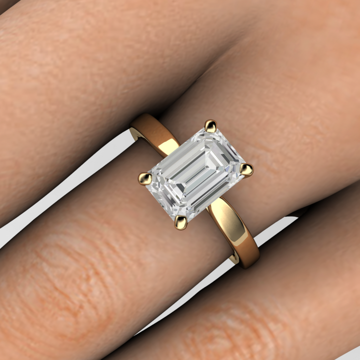 2ct emerald cut lab grown diamond solitaire engagement ring classic solitaire - close up on the finger