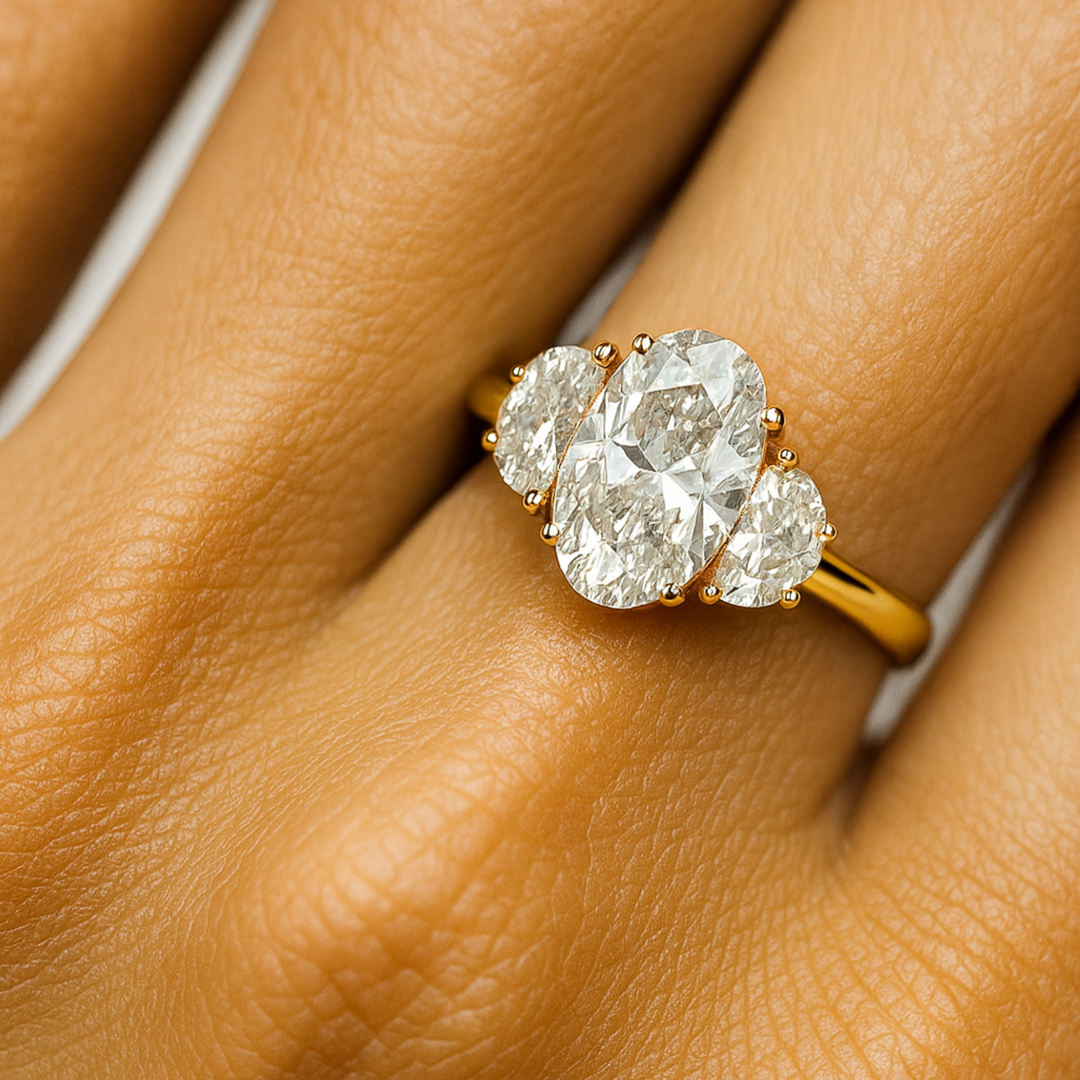 3 Stone Oval Diamond Engagement Ring on the Hand, Close up of 3 Carat Elongated Oval Lab Grown Diamond Ring on the Finger | Rare Earth Jewelry