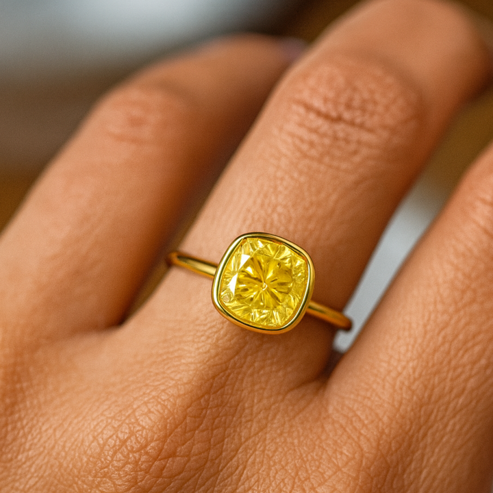 Cushion Cut Yellow Moissanite Ring on the Hand, Yellow Diamond Alternative Engagement Ring in Minimalist Style Bezel Setting with Thin Band | Rare Earth Jewelry
