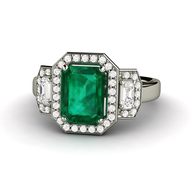 Green emerald three stone engagement ring.  Large emerald and diamond ring with diamond halo design.