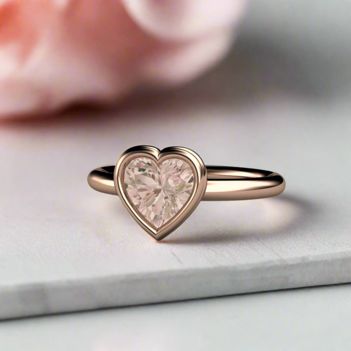 A pretty rose gold Morganite Ring in a simple heart-shaped bezel setting.  Natural Morganite solitaire engagement ring or promise ring.