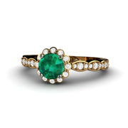 Round emerald ring in 18K Yellow Gold accented with diamonds.