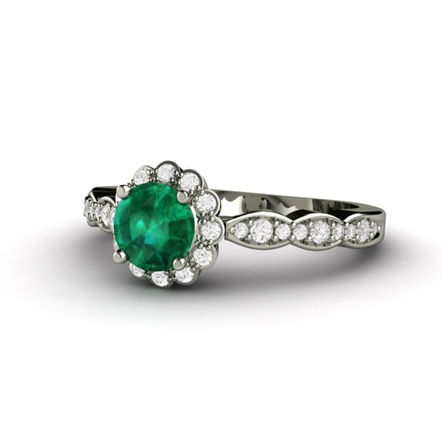 Round Emerald engagement ring with antique style diamond halo design and scalloped band.