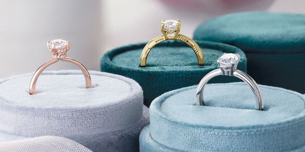 A selection of solitaire engagement rings in velvet boxes from Rare Earth Jewelry.